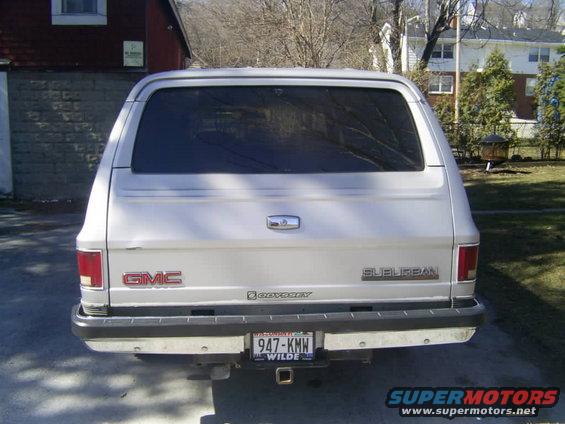 Silver GMC Suburban rear view, showing GMC and Suburban badging, and a license plate