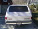 1985 Ford Bronco - Rear view of a silver GMC Suburban with a trailer hitch and a license plate.