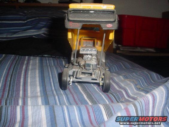 model dump truck with chrome engine and yellow bed, sitting on striped fabric