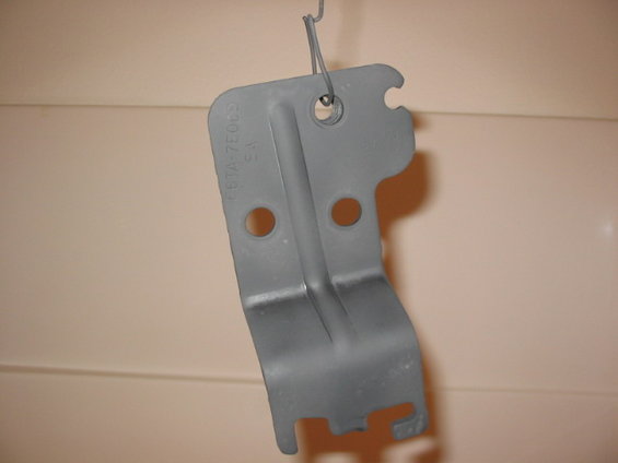 109_0976.jpg Just a pic of the shifter plate, you can almost make out the ford part number.  This plate is for the newer E4OD shifter that have a plunger/pushdown mechanism so you can't accidently shift into N or 4LO.  I disassembled the shifter to paint this, and lube up the shifter for years of future no-troubles operation