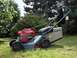1994 Ford Probe - A Honda lawnmower with a VTEC engine and custom wheels sits on a grassy lawn.