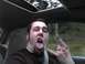 1994 Ford Probe - A man makes a rock-on hand gesture while sticking out his tongue, inside a car.