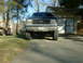 1991 Ford Bronco - This 1991 Ford Bronco is shown from the front, a lifted suspension and a dark-colored body.