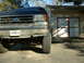 1991 Ford Bronco - Front view of a 1991 Ford Bronco parked in front of a garage.