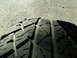 1991 Ford Bronco - Close-up of a tire tread on a gravel surface, showing the pattern and wear marks.
