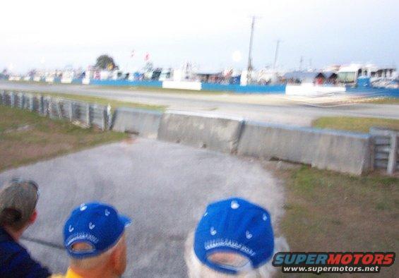 Race track scene with spectators wearing blue bandanas