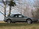 1996 Ford Probe - Side view of a gray 1996 Ford Probe coupe on a grassy field.