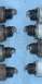1991 Ford Crown Victoria - Close-up of eight worn spark plugs, showing varying degrees of fouling and electrode damage.