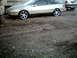 1989 Ford Probe - Side view of a silver 1989 Ford Probe coupe with aftermarket wheels.