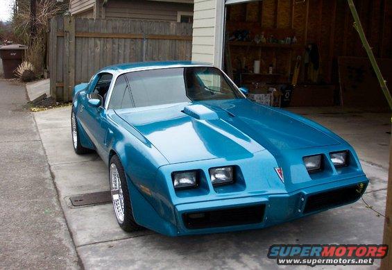 Blue 1979 Pontiac Trans Am parked in driveway with garage open behind it