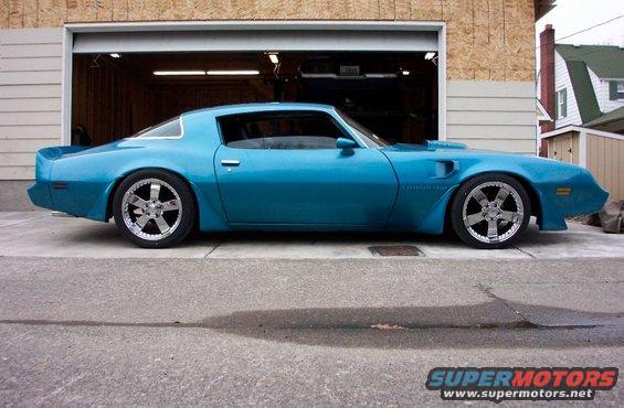 Blue 1979 Pontiac Trans Am parked in front of an open garage