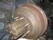 1986 Ford Bronco - A close-up view of a rusty brake drum and hub assembly from a vehicle.