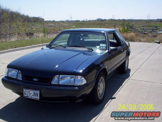 dark blue 1991 Ford Mustang coupe parked on concrete lot