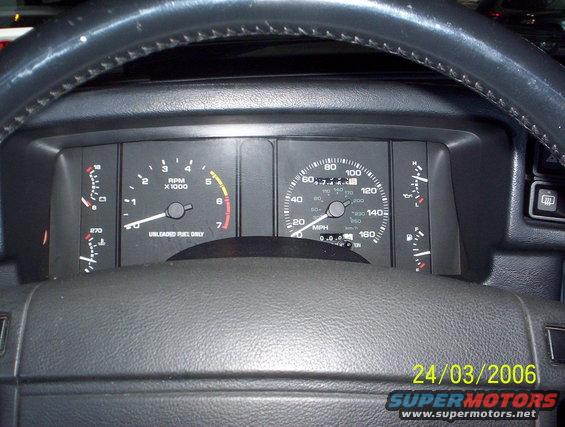 Dashboard with speedometer, tachometer, fuel gauge, and temp gauge. Date stamp 24/03/2006