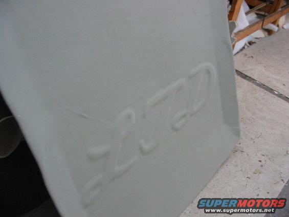 Embossed text that appears to read 'LTD' on a light gray panel