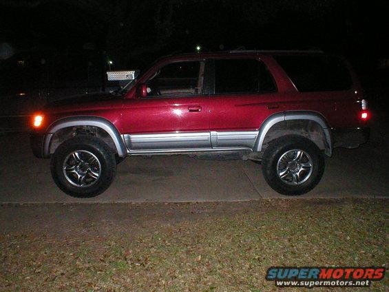 1996 Toyota 4Runner side view, red paint with silver trim, aftermarket wheels