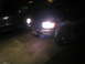 1996 Toyota 4Runner - Front view of a 1996 Toyota 4Runner at night, headlights illuminated. Another vehicle is parked alongside.
