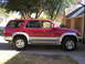 1996 Toyota 4Runner - This 1996 Toyota 4Runner is shown from the side, parked in a driveway on a sunny day.