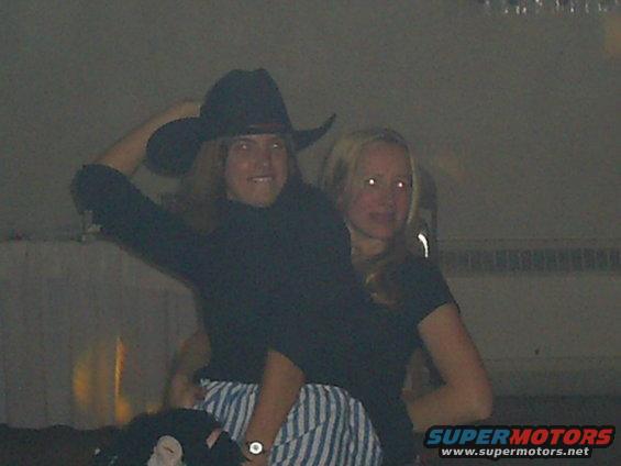 Person in cowboy hat and another person are posing for a photo