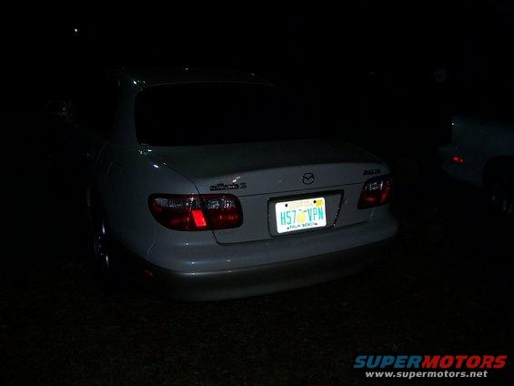 White sedan with a Florida license plate H57 VPN, rear view