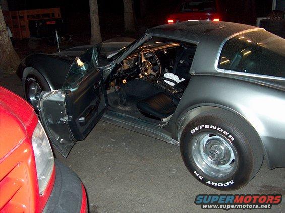 1979 Chevrolet Corvette interior with driver's door open, parked next to a red car