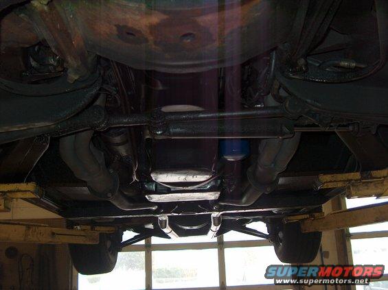 Undercarriage view showing exhaust pipes and suspension components