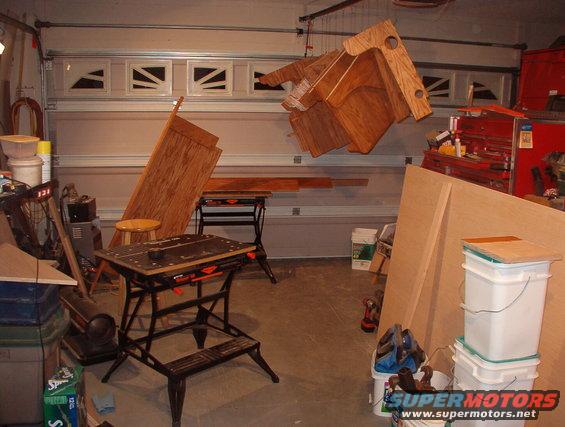 17stain.jpg We ironed on all the edge tape & stained everything but the TOP of the desktops.  I'll do that all at once when it's installed.  I had to do a LOT of cleaning in the garage to get it this cluttered. :-)