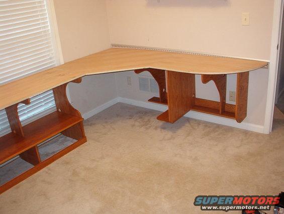 31mydesktest.jpg The smaller holes at the bottoms of the verticals are for power cords to run along the wall on the little shelf.  The larger ones up high are for data cables.  Nothing will be on the carpet but the chairs & some rolling storage carts that fit under the desk.