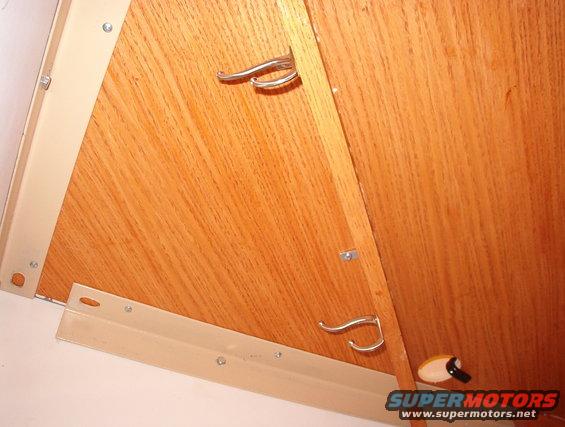 40mybrace.jpg I used PLENTY of screws along the back edges to hold the desktop in place & flat, and a bunch of shelf clips to hold it down on the braces.  These coathooks are for wires that run around the corners.