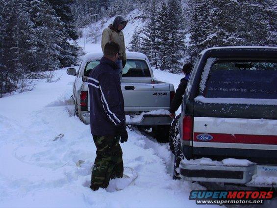 pictures-061.jpg The second stuck... 50 feet from the first, on the opposite side of the road.  Me trying to get the bronco around him to pull from the front.