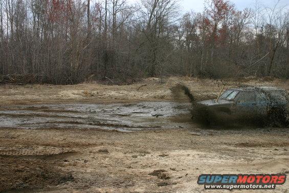 1989 Ford Bronco driving through mud, 3q-front view