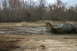 1989 Ford Bronco - This 1989 Ford Bronco navigates a muddy off-road course, kicking up a spray of dirt.
