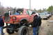 1989 Ford Bronco - Several modified trucks are lined up outdoors, with the foreground vehicle heavily customized.