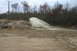 1989 Ford Bronco - An SUV drives through a muddy puddle, creating a large water splash.