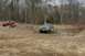 1989 Ford Bronco - A 1989 Ford Bronco navigates a muddy trail, with other off-road vehicles nearby.