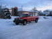1996 Dodge 2500 - A red 1996 Dodge 2500 pickup truck is parked on a snowy street in front of a suburban house.