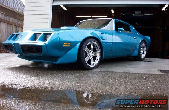 Blue 1979 Pontiac Trans Am parked in driveway with custom wheels