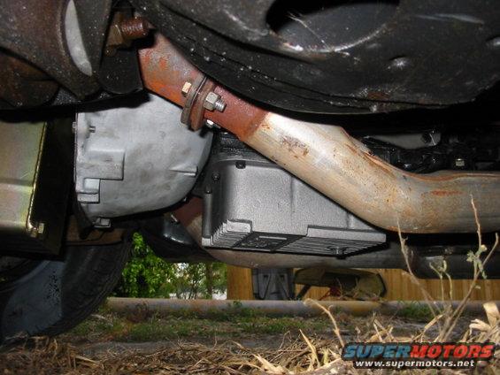 Underside view of vehicle transmission and exhaust pipe