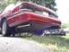 1995 Ford Crown Victoria - Rear view of a red 1995 Ford Crown Victoria, showing its dual exhaust system and taillights.