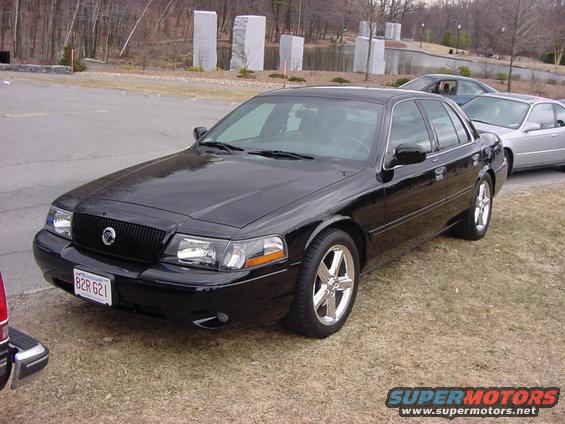 Black sedan with chrome wheels and a black grille