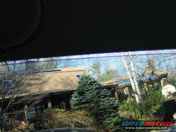 House and trees with a basketball hoop