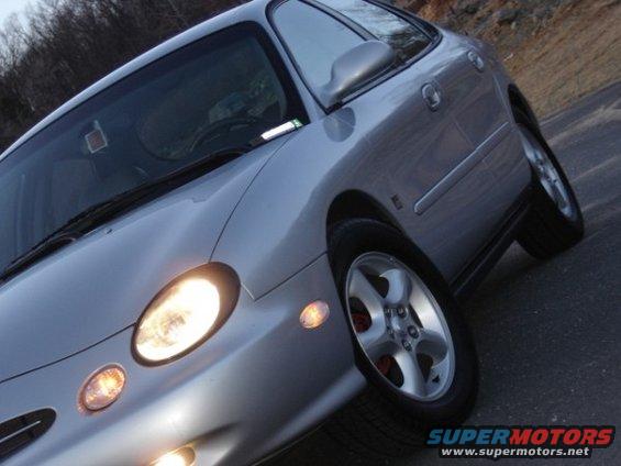 Silver 1999 Ford Taurus sedan, front quarter view, parked on a road