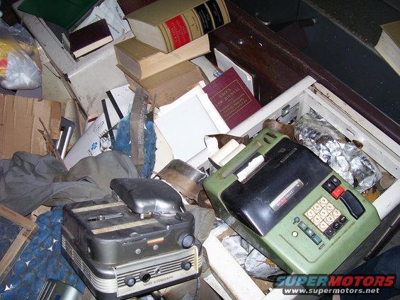 Cluttered room with vintage electronics and books