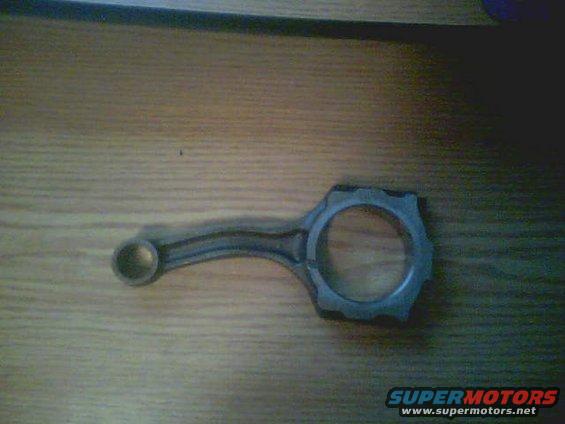 Connecting rod on wooden surface