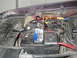 1992 Ford Crown Victoria - Close-up view of a vehicle's engine bay, focusing on the battery and its associated wiring.