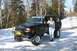 1995 Jeep Cherokee - A 1995 Jeep Cherokee is parked in the snow, with a woman standing beside it and a 'HIPPI CHICK' sticker on the windshield.