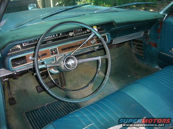 1966 Ford Galaxie interior with turquoise seats and woodgrain trim