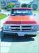 1970 GMC C/K Pickup - Front view of a red 1970 GMC C/K Pickup truck with a prominent chrome grille and dual headlights.