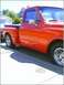 1970 GMC C/K Pickup - A bright red 1970 GMC C/K Pickup truck is seen from the side, parked on a sunny day.