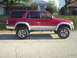 1996 Toyota 4Runner - This red 1996 Toyota 4Runner is shown from the side, a two-tone paint scheme and aftermarket wheels.